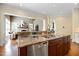 Gourmet kitchen island with granite countertops and stainless steel appliances overlooks the living room at 101 Bonica Creek Dr, Garner, NC 27529
