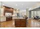 Gourmet kitchen featuring custom cabinets, granite counters, stainless appliances and island with seating at 101 Bonica Creek Dr, Garner, NC 27529