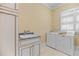 Well-equipped laundry room with built-in cabinets and modern washer/dryer at 101 Bonica Creek Dr, Garner, NC 27529