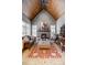 Elegant living room with a stone fireplace, wood-paneled ceiling, and hardwood floors covered with a stylish rug at 101 Bonica Creek Dr, Garner, NC 27529