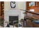 Close up of a fireplace and grand piano with hardwood floors and built-in shelves at 101 Bonica Creek Dr, Garner, NC 27529