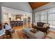 Open floor plan living room with kitchen view, hardwood floors, and leather furniture at 101 Bonica Creek Dr, Garner, NC 27529