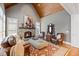 Comfortable living room with vaulted wood ceiling, stone fireplace, leather seating and antique vanity at 101 Bonica Creek Dr, Garner, NC 27529