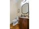 Elegant powder room with a stylish mirror, designer fixtures, and warm lighting at 101 Bonica Creek Dr, Garner, NC 27529