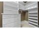 Well-organized walk-in closet with built-in shelving and drawers for maximum storage and organization at 101 Bonica Creek Dr, Garner, NC 27529