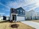 Two-story house with blue siding, white garage door, and landscaping at 110 Gabriel Ct, Clayton, NC 27520