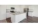 Modern kitchen with white cabinets, granite island, and stainless appliances at 110 Gabriel Ct, Clayton, NC 27520