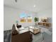 Open living room featuring a brown couch and large windows at 110 Gabriel Ct, Clayton, NC 27520