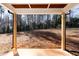 Covered back porch overlooking a wooded backyard at 110 Mohave Dr, Louisburg, NC 27549