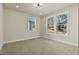Bright bedroom with carpeted floors and large windows at 110 Mohave Dr, Louisburg, NC 27549