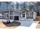 Modern gray house with white stone accents and a two-car garage at 110 Mohave Dr, Louisburg, NC 27549
