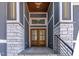 Double wooden front door with a modern design and stone accents at 110 Mohave Dr, Louisburg, NC 27549