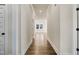 Long hallway with hardwood floors and white walls at 110 Mohave Dr, Louisburg, NC 27549