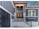Modern house entrance with stone steps and a double wooden door at 110 Mohave Dr, Louisburg, NC 27549