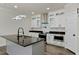 Modern kitchen with white cabinets, granite counters, and island at 110 Mohave Dr, Louisburg, NC 27549