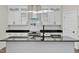 Modern kitchen with white cabinets, granite counters, and island at 110 Mohave Dr, Louisburg, NC 27549