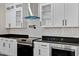 Modern kitchen with white cabinets and stainless steel appliances at 110 Mohave Dr, Louisburg, NC 27549