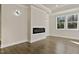 Living room featuring a fireplace and large windows at 110 Mohave Dr, Louisburg, NC 27549