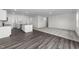 Open concept kitchen and living room with vinyl plank and carpet flooring at 148 Babbling Brook Dr, Clayton, NC 27520