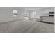 Open concept kitchen and living room with vinyl plank and carpet flooring at 148 Babbling Brook Dr, Clayton, NC 27520