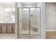 Bright bathroom featuring a tiled shower with a glass door and a convenient built-in seat at 1975 Meadowview Dr, Graham, NC 27253