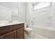 Well-lit bathroom with a sleek vanity, toilet, and a combined shower and tub at 1975 Meadowview Dr, Graham, NC 27253