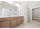Modern bathroom featuring a double vanity, walk-in shower, and contemporary fixtures at 1975 Meadowview Dr, Graham, NC 27253