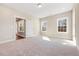 Inviting bedroom with plush carpeting, plenty of natural light, and a fresh, neutral decor at 1975 Meadowview Dr, Graham, NC 27253