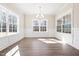 Bright dining room with large windows, modern chandelier, and a clean, neutral color scheme at 1975 Meadowview Dr, Graham, NC 27253