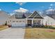 Charming single-Gathering home featuring a two-car garage, well-maintained lawn, and inviting front porch at 1975 Meadowview Dr, Graham, NC 27253