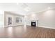 Inviting living room featuring a cozy fireplace, neutral paint, and access to the backyard at 1975 Meadowview Dr, Graham, NC 27253