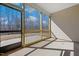Screened-in porch with a view of the trees beyond and space for outdoor seating at 1975 Meadowview Dr, Graham, NC 27253