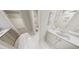 Well-lit bathroom features double sinks, a walk-in closet, and elegant tile flooring at 290 Beacon Dr, Pittsboro, NC 27312