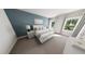 Cozy bedroom with a serene blue accent wall and comfortable furnishings, flooded with natural light at 290 Beacon Dr, Pittsboro, NC 27312