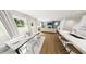 Bright dining area with large windows, modern furniture, and seamless connection to the kitchen and living room at 290 Beacon Dr, Pittsboro, NC 27312