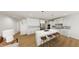 Bright kitchen with white cabinets, stainless steel appliances, and a large center island with seating at 290 Beacon Dr, Pittsboro, NC 27312