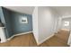 Living room with hardwood floors, a large window, and neutral paint, creating a calming and inviting space at 290 Beacon Dr, Pittsboro, NC 27312