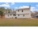 Large backyard with white two-story home featuring a brick chimney and room for outdoor activities at 3305 Victor Pl, Raleigh, NC 27604
