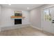 Basement with fireplace, laminate floor, and exterior access at 3305 Victor Pl, Raleigh, NC 27604