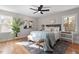 Bright bedroom featuring hardwood floors, a ceiling fan, neutral walls, and coordinated decor at 3305 Victor Pl, Raleigh, NC 27604