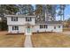 Charming white two-story home featuring a manicured lawn, fresh landscaping, and an eye-catching light-blue front door at 3305 Victor Pl, Raleigh, NC 27604