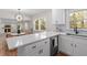 Bright kitchen features white cabinets, quartz countertops, stainless steel appliances, and breakfast table at 3305 Victor Pl, Raleigh, NC 27604
