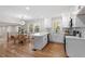 Modern kitchen with white cabinets, quartz countertops, and hardwood floors at 3305 Victor Pl, Raleigh, NC 27604