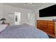 Main bedroom with large TV, dresser, and ensuite bathroom at 36 Mae Ct, Roxboro, NC 27573