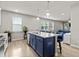 Open kitchen with blue island, stainless steel appliances, and hardwood floors at 36 Mae Ct, Roxboro, NC 27573