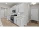 White kitchen cabinets, granite countertops, and stainless steel appliances at 36 Mae Ct, Roxboro, NC 27573