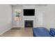 Bright living room featuring a fireplace and large TV at 36 Mae Ct, Roxboro, NC 27573
