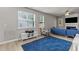 Living room with blue couch, fireplace, and large TV at 36 Mae Ct, Roxboro, NC 27573