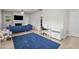 Living room with blue rug, white desk, and blue couch at 36 Mae Ct, Roxboro, NC 27573