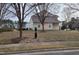 A view of the backyard of the property, featuring a well-kept lawn and landscaping at 4202 Cherry Blossom Cir, Durham, NC 27713